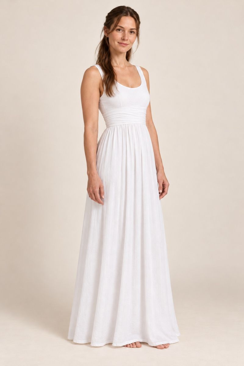 White empire-waist gown — gentle three-quarter front view