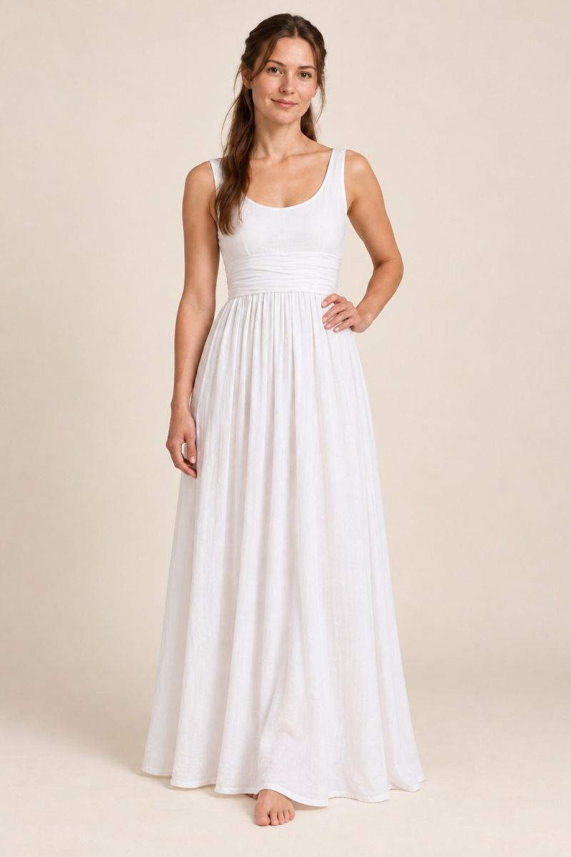 White empire-waist gown — alternative front pose with hand at waist